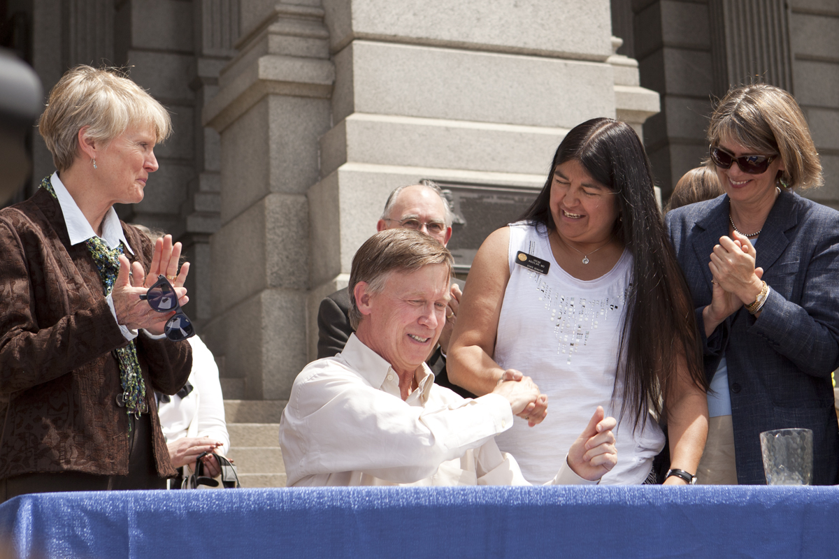 Hickenlooper signing Medicaid expansion.