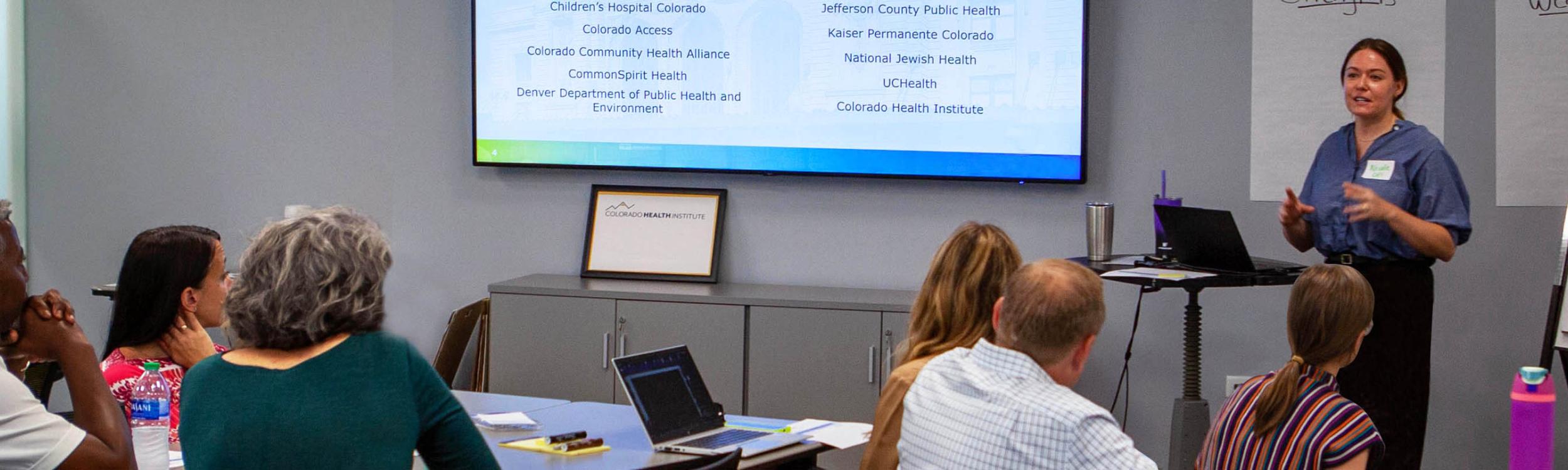 CHI's Nicole Steffens presents to a group during a meeting