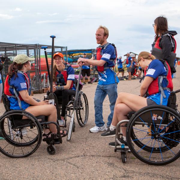 From left, Team Blue athletes Lauren Slack, Liz Mahoney, Alison Rehfus, Frank Kane, Claire Thomas, and Raegan Bowyer prepare to load into the boat during a recent practice.